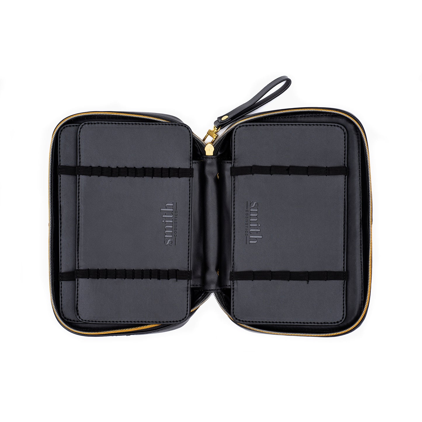 A black leather makeup case opened to show interior compartments to store makeup brushes in